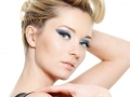 Glamour woman with blue eye make-up and curly hairstyle