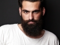portrait of tattooed bearded man wearing blank t-shirt