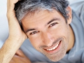 Closeup portrait of smiling man lying on sofa