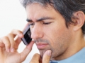 Mature man looking worried while talking on mobile phone
