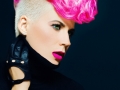 Sensual portrait lady with fashionable haircut colored hair on a black background